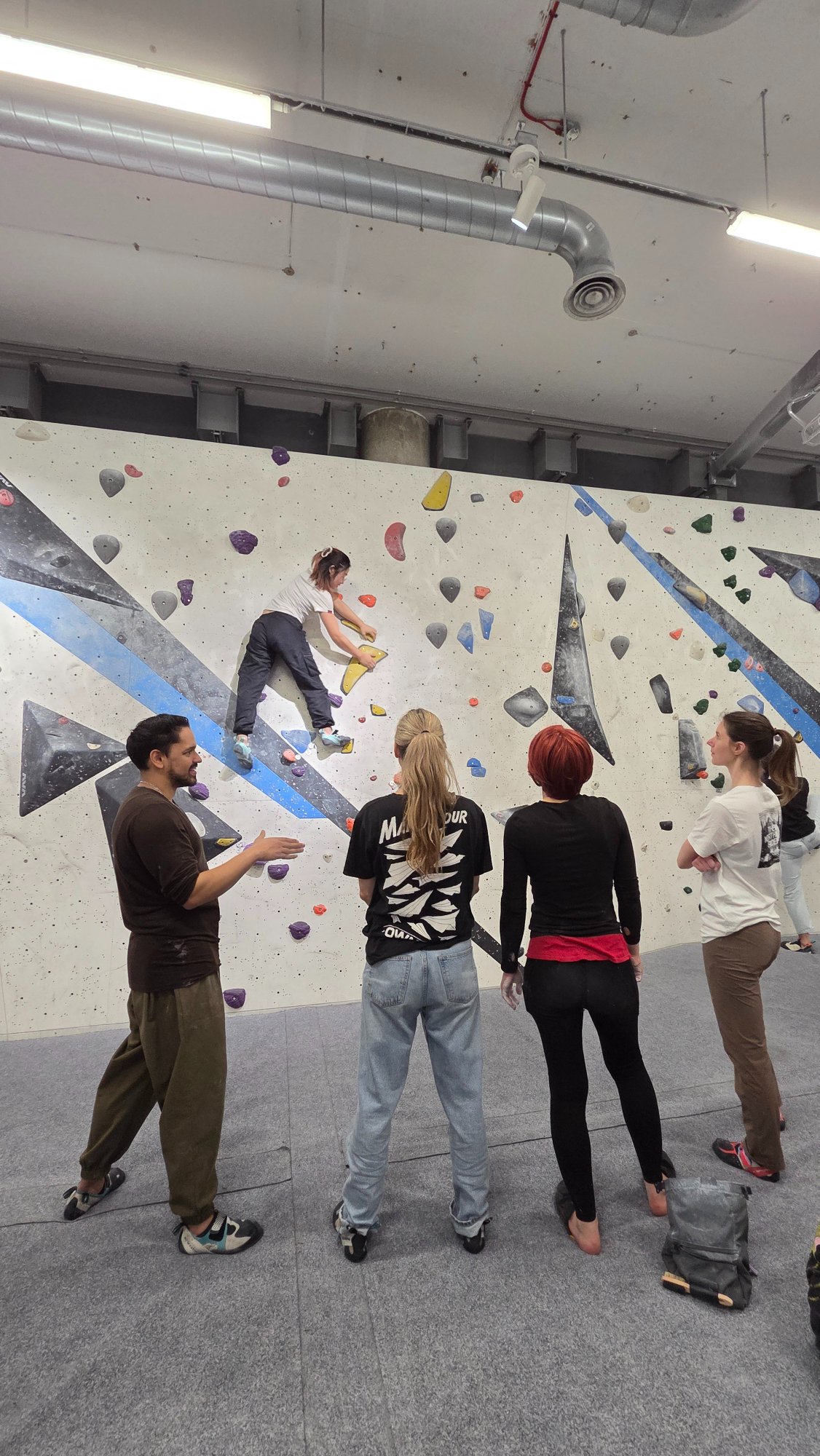 Group session watching a climber on the wall